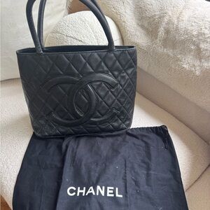 Chanel black quilted shoulder bag with gold medallion charm